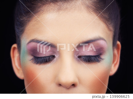 Colorful, makeup and creative eyeshadow with woman in studio and black background with beauty. Cosmetics, creativity and model with unique rainbow aesthetic on face to glow or shine with confidence 139906625