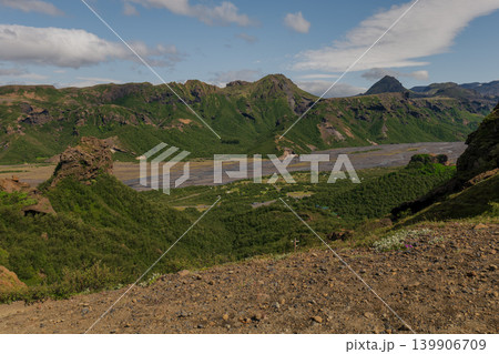 Lush Green Valley with River and Rugged Mountains in Eastern Iceland Lush Green Valley with River and Rugged Mountains in Eastern Iceland 139906709