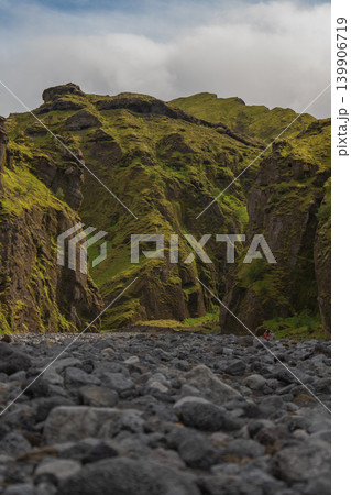 Visitors Explore Moss Covered Cliffs and Basalt Rocks in Iceland Visitors Explore Moss Covered Cliffs and Basalt Rocks in Iceland 139906719