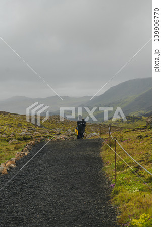 Traveler Walks Along Gravel Path in Iceland's Rugged Countryside Traveler Walks Along Gravel Path in Iceland's Rugged Countryside 139906770