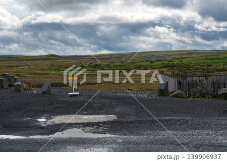 Rural Icelandic Landscape with Gravel Parking Area and Yellow Sign 139906937