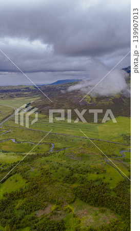 Aerial View of a Green Valley with River and Winding Road in Iceland Aerial View of a Green Valley with River and Winding Road in Iceland 139907013