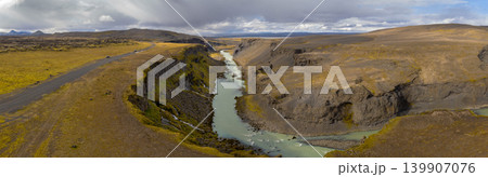 Aerial View of Icelandic Canyon with Turquoise River and Rugged Cliffs Aerial View of Icelandic Canyon with Turquoise River and Rugged Cliffs 139907076