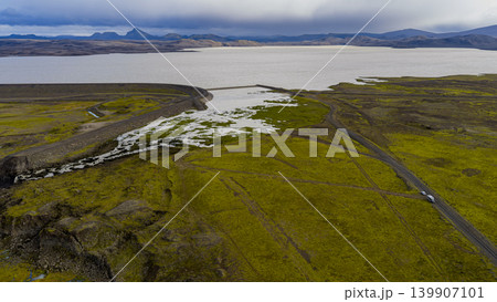 Aerial View of Icelandic Lake, Dam, Waterfall, and Mossy Terrain 139907101