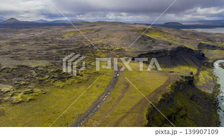 Aerial View of Icelandic Volcanic Terrain with Winding Road and Cliffs 139907109