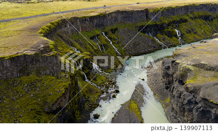 Aerial View of Icelandic Canyon with Mossy Cliffs and Glacial River Aerial View of Icelandic Canyon with Mossy Cliffs and Glacial River 139907113