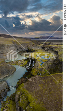 Aerial View of Icelandic Waterfall, River, and Moss Covered Cliffs Aerial View of Icelandic Waterfall, River, and Moss Covered Cliffs 139907116