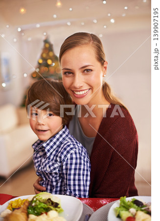 Mother, child and portrait with Christmas dinner for celebration, smile and bond over festive season. Parent, kid and together with meal for celebration, xmas and holiday with food for family 139907195