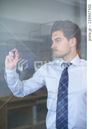 Businessman, idea and mindmap on glass wall for strategy, thinking and planning in office. Innovation, vision and professional man with illustration for brainstorming, analysis and problem solving Businessman, idea and mindmap on glass wall for strategy, thinking and planning in office. Innovation, vision and professional man with illustration for brainstorming, analysis and problem solving 139907308