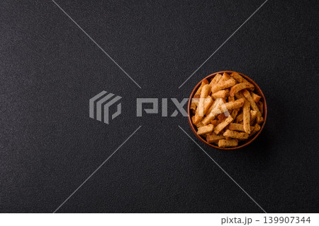 Croutons or crackers made from rye bread with garlic, salt, and spices. Croutons with salt Croutons or crackers made from rye bread with garlic, salt, and spices. Croutons with salt 139907344