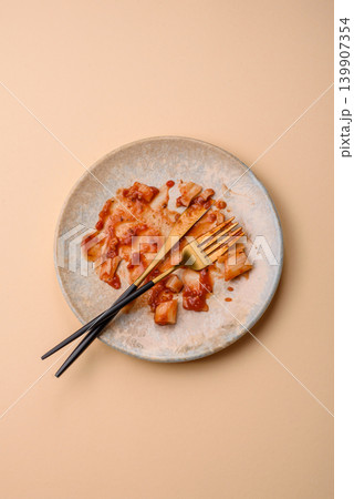 A dirty plate after a meal with leftover pasta and tomato sauce, cleaning. An empty dirty plate A dirty plate after a meal with leftover pasta and tomato sauce, cleaning. An empty dirty plate 139907354