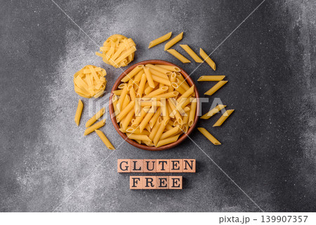 Italian uncooked, dry, gluten free penne pasta, ready for cooking. Dry, gluten free penne pasta Italian uncooked, dry, gluten free penne pasta, ready for cooking. Dry, gluten free penne pasta 139907357