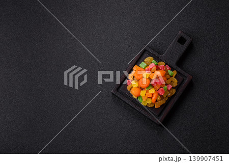 Dried apricots, raisins, and candied fruits as ingredients for baked goods and sweets. Dried fruits Dried apricots, raisins, and candied fruits as ingredients for baked goods and sweets. Dried fruits 139907451