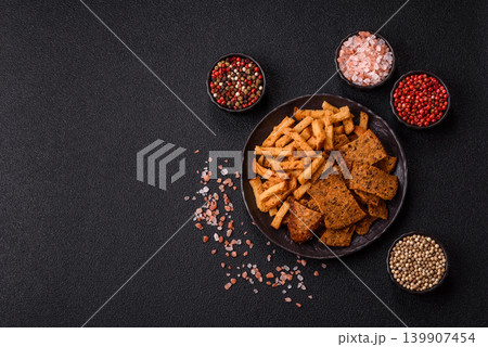 Croutons or crackers made from rye bread with garlic, salt, and spices. Croutons with salt 139907454