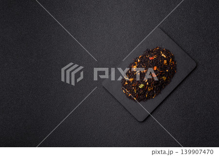 Dry black tea with herbal leaves and aromatic additives. Dry fruity black tea 139907470