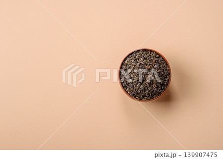 Granules of dried organic Chinese green tea with herbal additives. Dry green tea Granules of dried organic Chinese green tea with herbal additives. Dry green tea 139907475