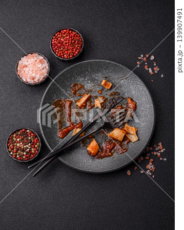 A dirty plate after a meal with leftover pasta and tomato sauce, cleaning. An empty dirty plate A dirty plate after a meal with leftover pasta and tomato sauce, cleaning. An empty dirty plate 139907491