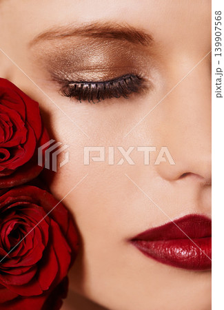 Closeup of face, makeup and beauty with roses, red lipstick and gold eyeshadow with lashes for cosmetics. Shimmer, shine and bold aesthetic, romantic flowers and cropped with skin and cosmetology Closeup of face, makeup and beauty with roses, red lipstick and gold eyeshadow with lashes for cosmetics. Shimmer, shine and bold aesthetic, romantic flowers and cropped with skin and cosmetology 139907568