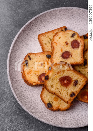Fruit cake, a dessert with cherries, plums, and raisins for a festive Christmas table. Fruit cake Fruit cake, a dessert with cherries, plums, and raisins for a festive Christmas table. Fruit cake 139907596