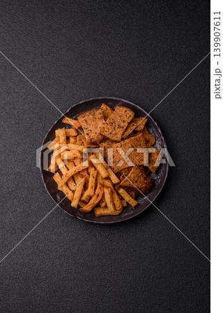 Croutons or crackers made from rye bread with garlic, salt, and spices. Croutons with salt 139907611