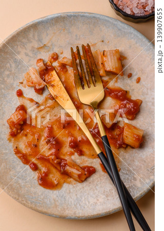 A dirty plate after a meal with leftover pasta and tomato sauce, cleaning. An empty dirty plate A dirty plate after a meal with leftover pasta and tomato sauce, cleaning. An empty dirty plate 139907655