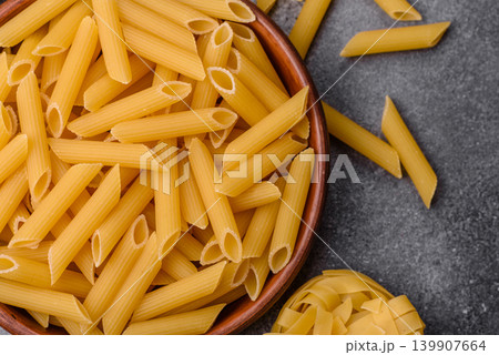 Italian uncooked dry penne regate pasta ready for cooking. Dry penne pasta 139907664