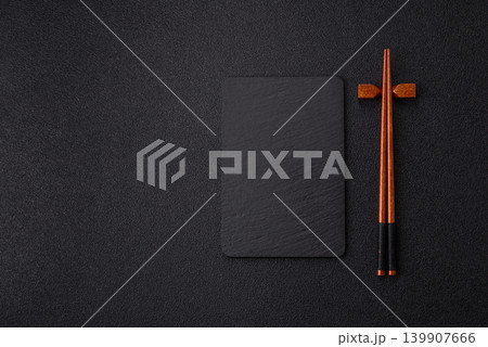 Empty slate board with wooden chopsticks for Asian food. Empty slate board Empty slate board with wooden chopsticks for Asian food. Empty slate board 139907666