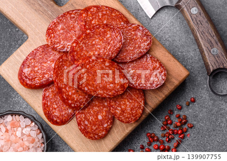 Sliced smoked pepperoni or salami as a pizza topping. Pepperoni sausage 139907755