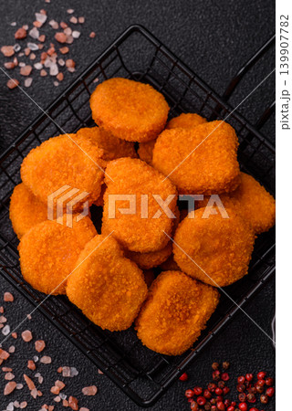 Fried chicken nuggets with sauce, salt, and spices, fast food, unhealthy food. Chicken nuggets 139907782