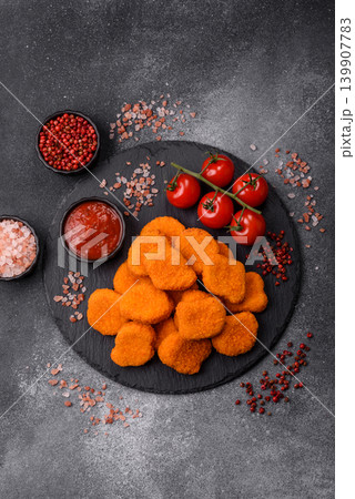 Fried chicken nuggets with sauce, salt, and spices, fast food, unhealthy food. Chicken nuggets 139907783