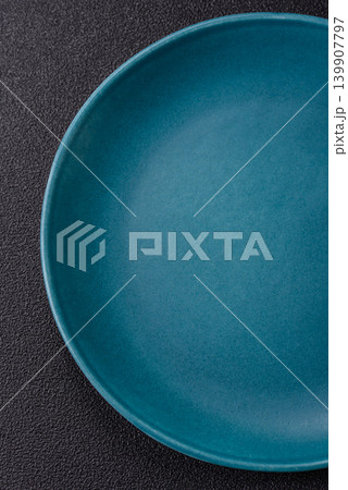 An empty ceramic round plate, kitchen utensils for a dinner table. An empty plate An empty ceramic round plate, kitchen utensils for a dinner table. An empty plate 139907797