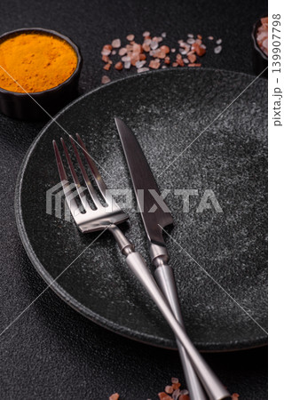 An empty ceramic round plate, kitchen utensils for a dinner table. An empty plate An empty ceramic round plate, kitchen utensils for a dinner table. An empty plate 139907798