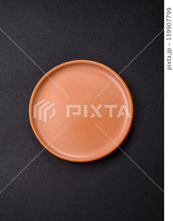 An empty ceramic round plate, kitchen utensils for a dinner table. An empty plate An empty ceramic round plate, kitchen utensils for a dinner table. An empty plate 139907799