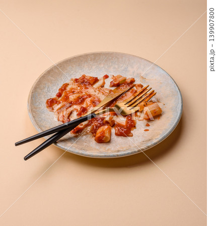 A dirty plate after a meal with leftover pasta and tomato sauce, cleaning. An empty dirty plate 139907800