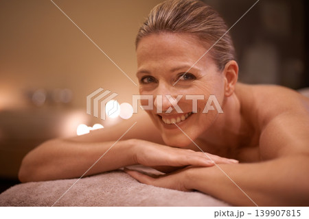 Portrait, massage and relax with woman, smile and luxury with wellness and spa with skincare. Face, candles and mature person with peace and zen with treatment and vacation with self care and detox 139907815