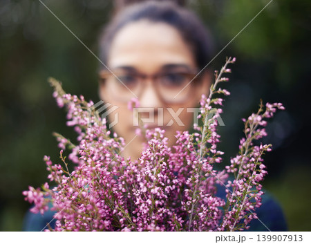 Woman, face and flowers as gift outdoor in nature for gardening in spring and plant for harmony. Peace, backyard and home to calm person with present of fresh bouquet in purple to relax and enjoy Woman, face and flowers as gift outdoor in nature for gardening in spring and plant for harmony. Peace, backyard and home to calm person with present of fresh bouquet in purple to relax and enjoy 139907913