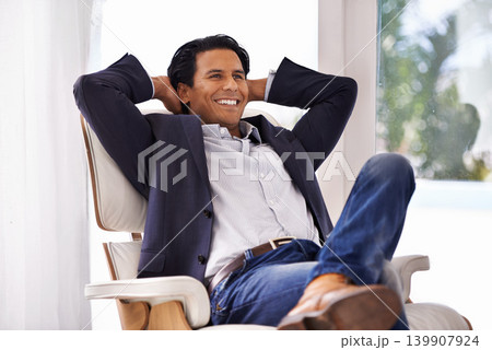 Relax, stretching and businessman on a chair with relieved, smile or excited about work success in his home. Happy, chilling and male entrepreneur in a living room with chill, moment or stress relief Relax, stretching and businessman on a chair with relieved, smile or excited about work success in his home. Happy, chilling and male entrepreneur in a living room with chill, moment or stress relief 139907924