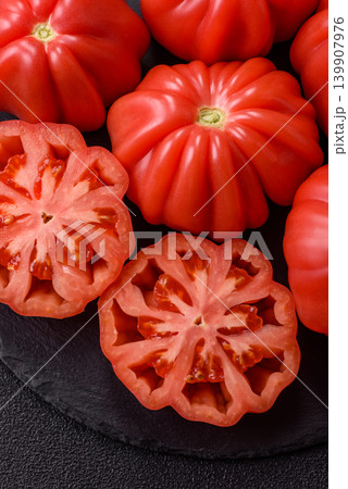 Fresh pink heirloom ribbed tomatoes as an ingredient for a lunch salad. Ribbed heirloom tomatoes 139907976