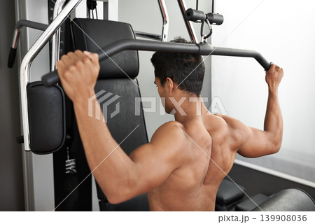 Fitness, shoulder press and back of man in studio on gray background for training or workout at gym. Exercise, health or pull down machine and body builder with equipment for wellness or strength 139908036