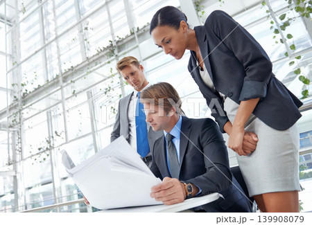 Business people, architect and meeting, review blueprint for building renovation with team strategy and project management. Construction collaboration, engineering and architecture floor plan Business people, architect and meeting, review blueprint for building renovation with team strategy and project management. Construction collaboration, engineering and architecture floor plan 139908079