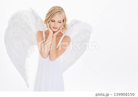 Woman, face and beauty in studio with angel wings for halloween dress up, celestial fashion and confidence. Model, person and thinking with heavenly costume and purity aesthetic on white background 139908150