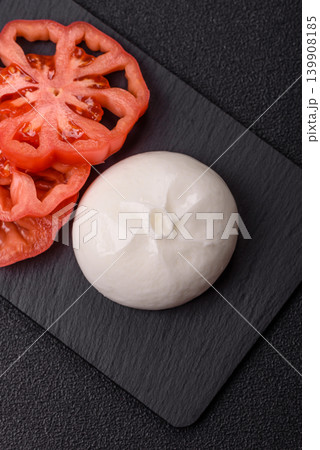Fresh white burrata cheese with tomatoes for a salad. Burrata cheese Fresh white burrata cheese with tomatoes for a salad. Burrata cheese 139908185