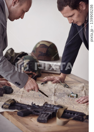 Planning, map and men soldiers in military in discussion for war battlefield with guns. Teamwork, conversation and male army heros working on fighting strategy with paperwork for armed forces gear. 139908286