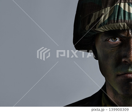 Man, portrait and soldier with camouflage for army, military war or battle on a gray studio background. Closeup of male person or commander with face paint or helmet in undercover disguise on mockup 139908309