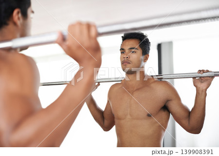 Man, barbell and weightlifting at mirror for exercise as bodybuilder or workout strength, wellness or routine. Male person, equipment and reflection in Miami for training challenge, biceps or topless Man, barbell and weightlifting at mirror for exercise as bodybuilder or workout strength, wellness or routine. Male person, equipment and reflection in Miami for training challenge, biceps or topless 139908391