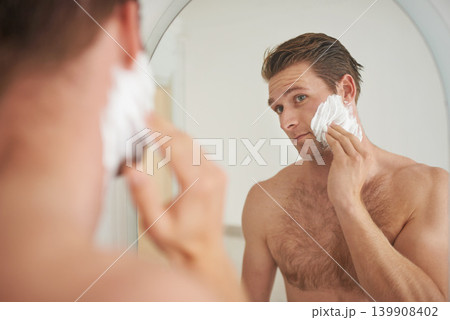 Mirror, skincare and man with shaving cream application in a bathroom for morning, routine or hygiene. Hair removal, foam and male person in a house with facial product for beauty, wellness or care Mirror, skincare and man with shaving cream application in a bathroom for morning, routine or hygiene. Hair removal, foam and male person in a house with facial product for beauty, wellness or care 139908402