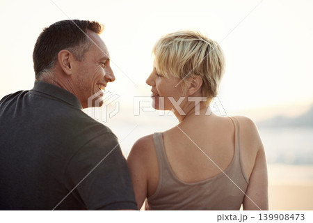 Couple, smile and beach relax at sunset in summer on tropical island for paradise, marriage or stress relief. Man, woman and evening in California together for ocean view or travel, peace or date Couple, smile and beach relax at sunset in summer on tropical island for paradise, marriage or stress relief. Man, woman and evening in California together for ocean view or travel, peace or date 139908473