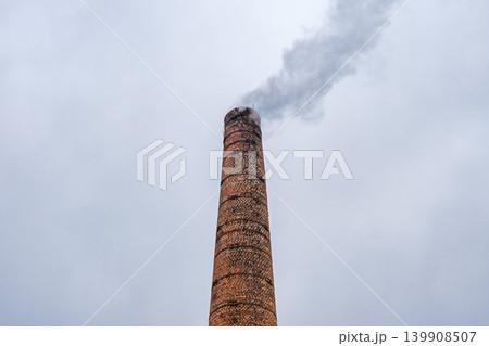 smoking industrial brick chimney at sky background smoking industrial brick chimney at sky background 139908507