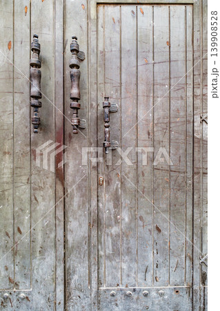 old wooden gate with door and metal handles 139908528