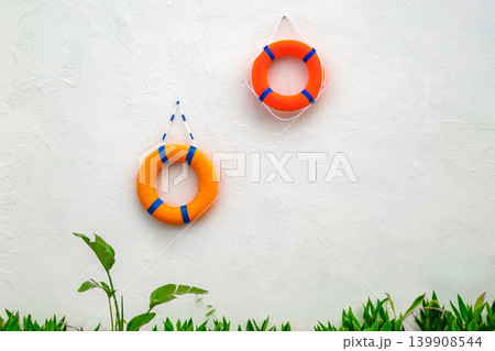 lifebuoys hanging on a white wall lifebuoys hanging on a white wall 139908544